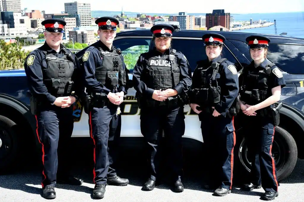 Saint John Police officers standing together near patrol vehicles